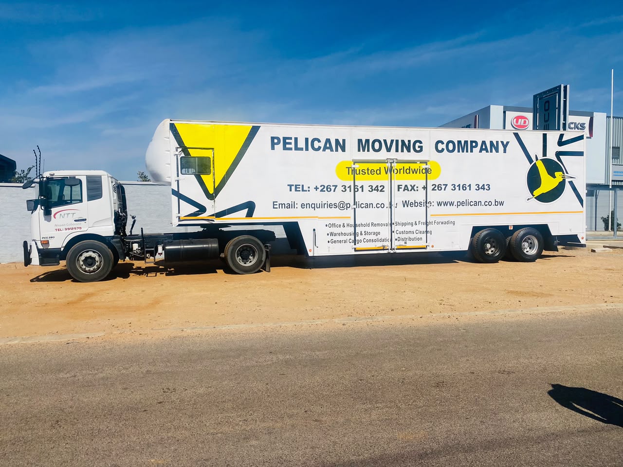 Cardboard boxes and a delivery truck ready for international shipping